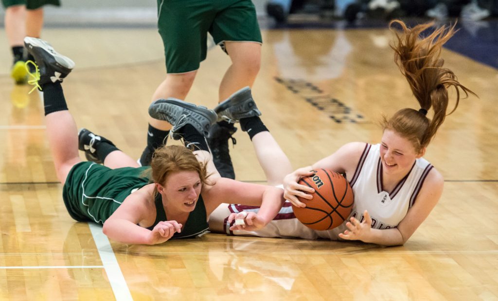 Anna Hutchings of Adrian and North Douglas Riley Black dive for a basketball in the 1A quarterfinal game Thursday. Adrian upset North Douglas 46-33.(Photo: Aaron Yost)